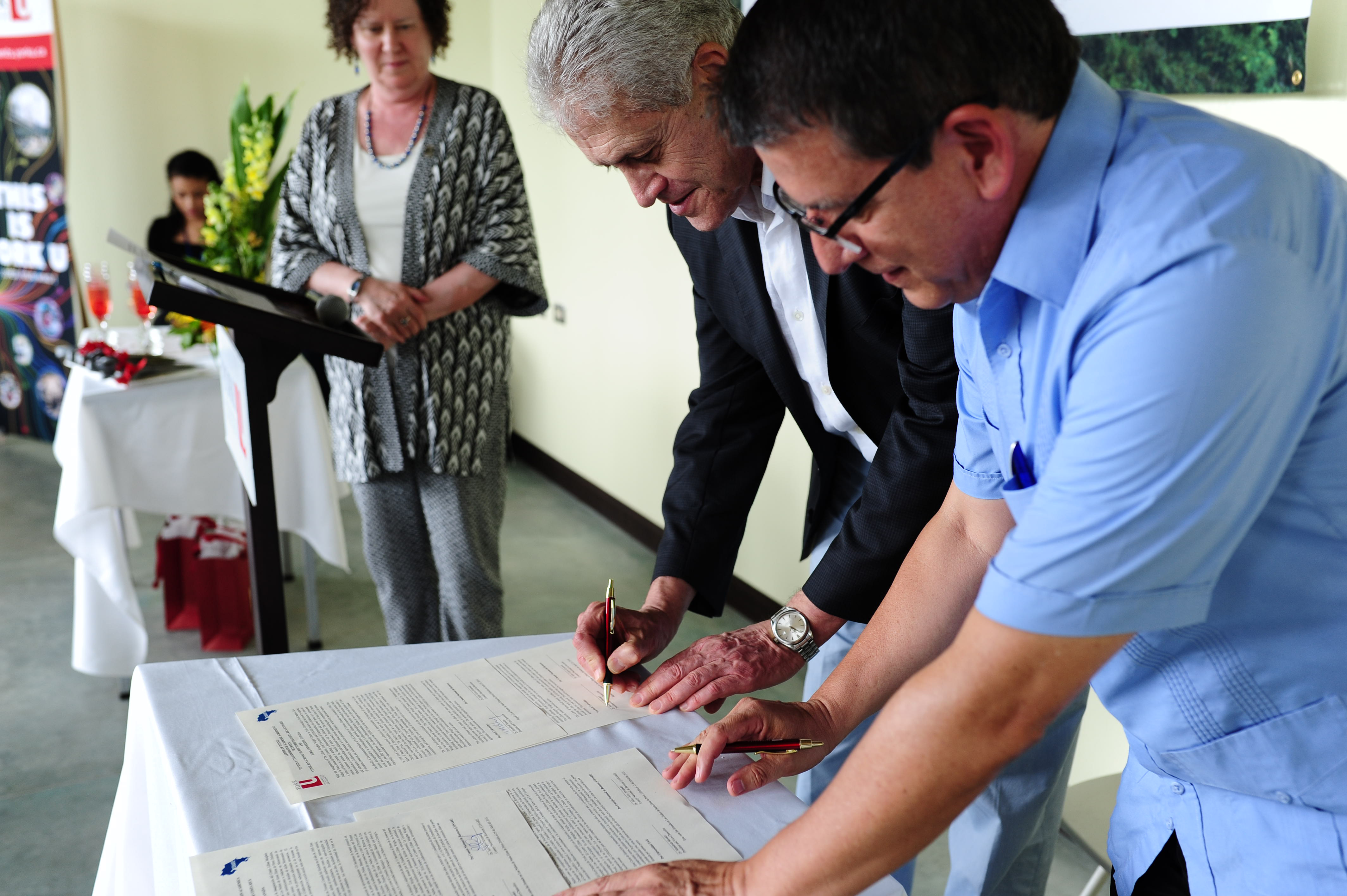 Faculty of Environmental Studies Dean Noel Sturgeon overlooking the signing between York University President and Vice-Chancellor Mamdouh Shoukri and Julio Calvo, representative of CONARE, merging together York and CONARE in research and study exchanges